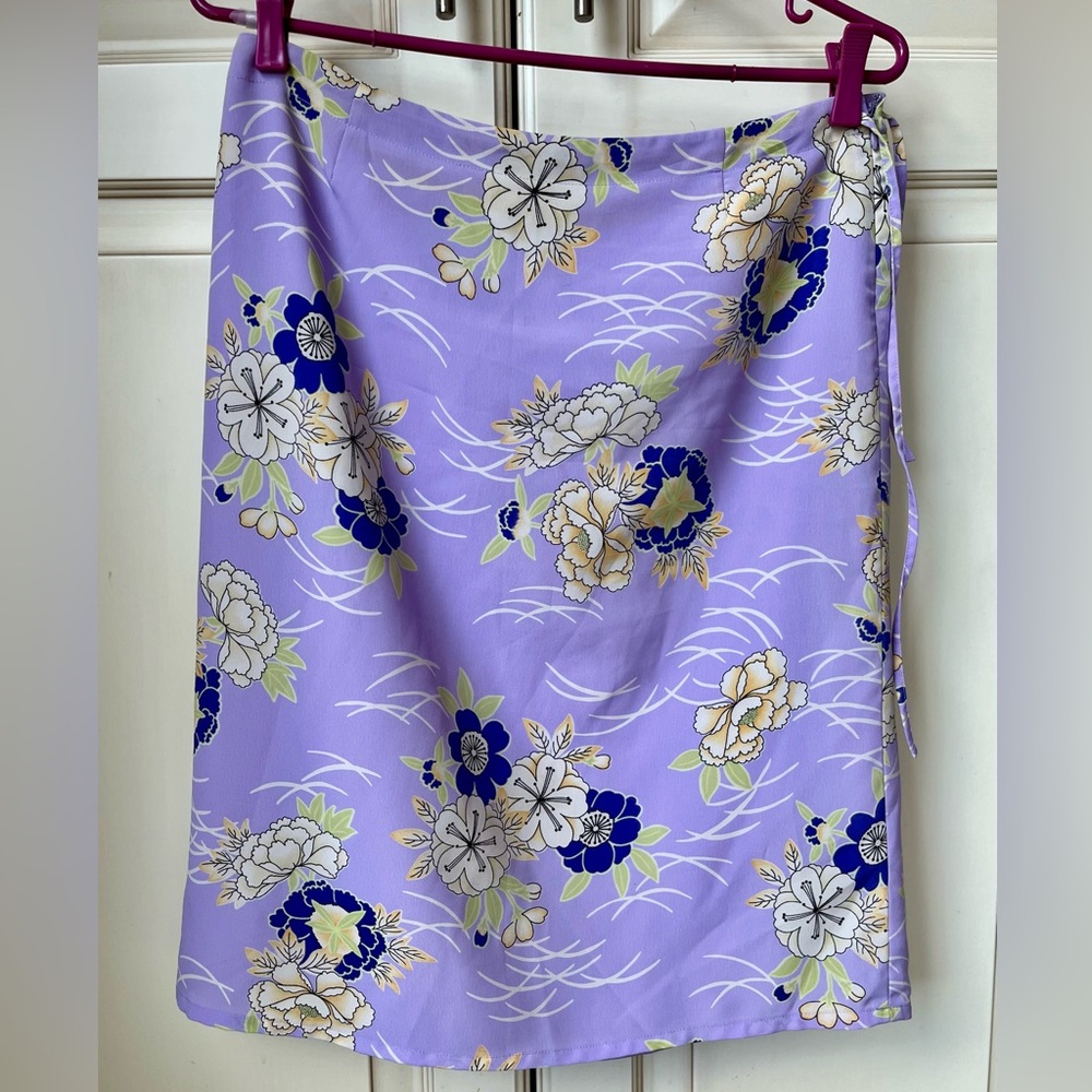 In Wear size 8 purple skirt with floral pattern. From 2000’s.